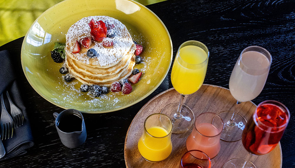 Pancakes with berries and an assortment of cocktails