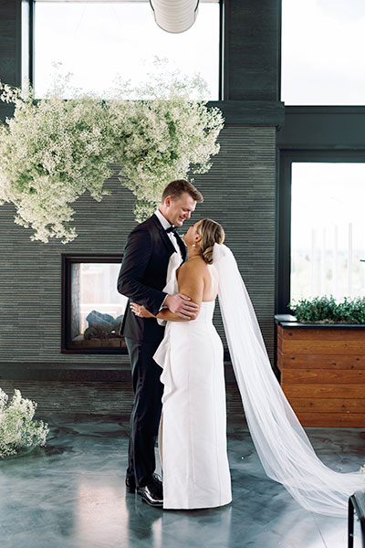 a couple kissing under a tree of flowers