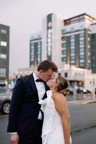 a couple kissing under a tree of flowers