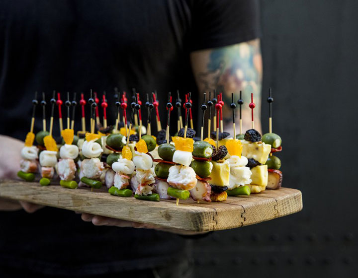 server with a platter of small bites