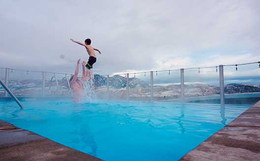 kid jumping in pool